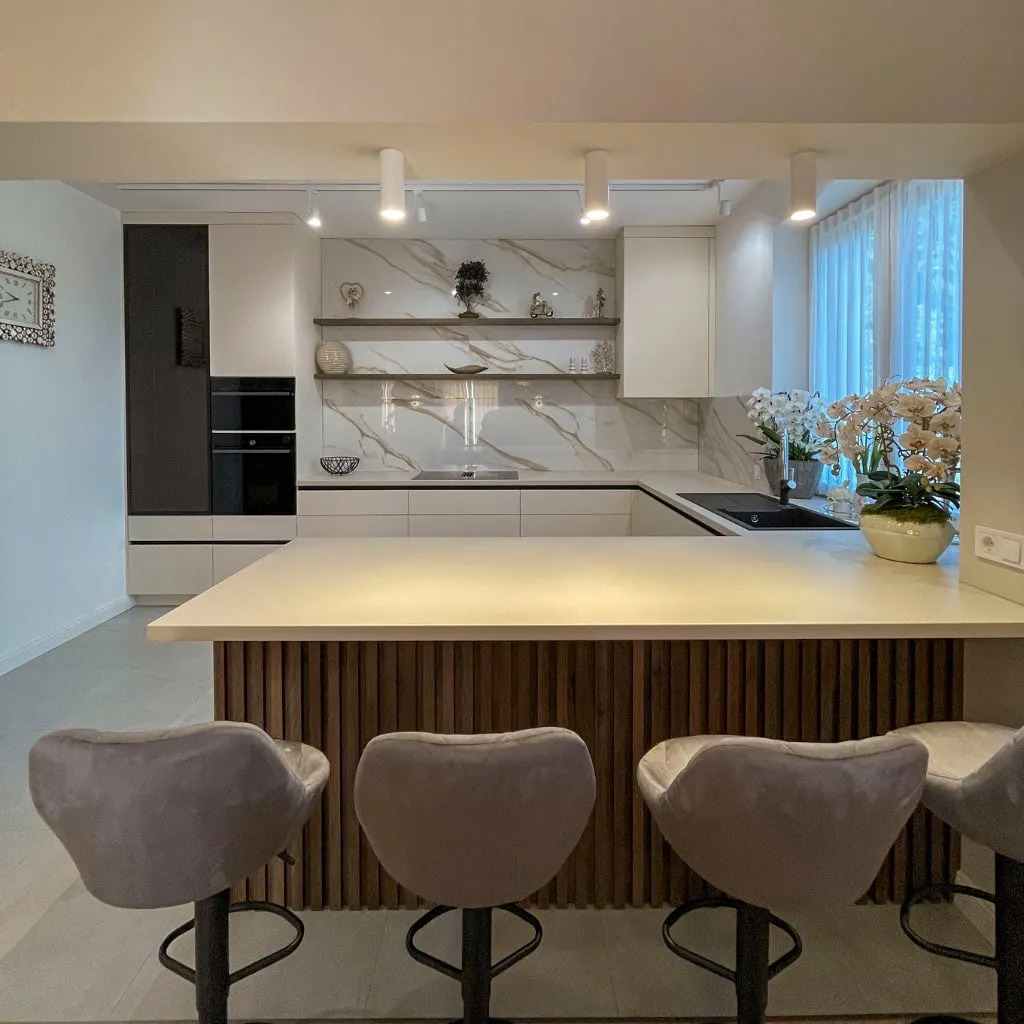 Kitchen with a ribbed dark oak island and a gold-veined marble splashback