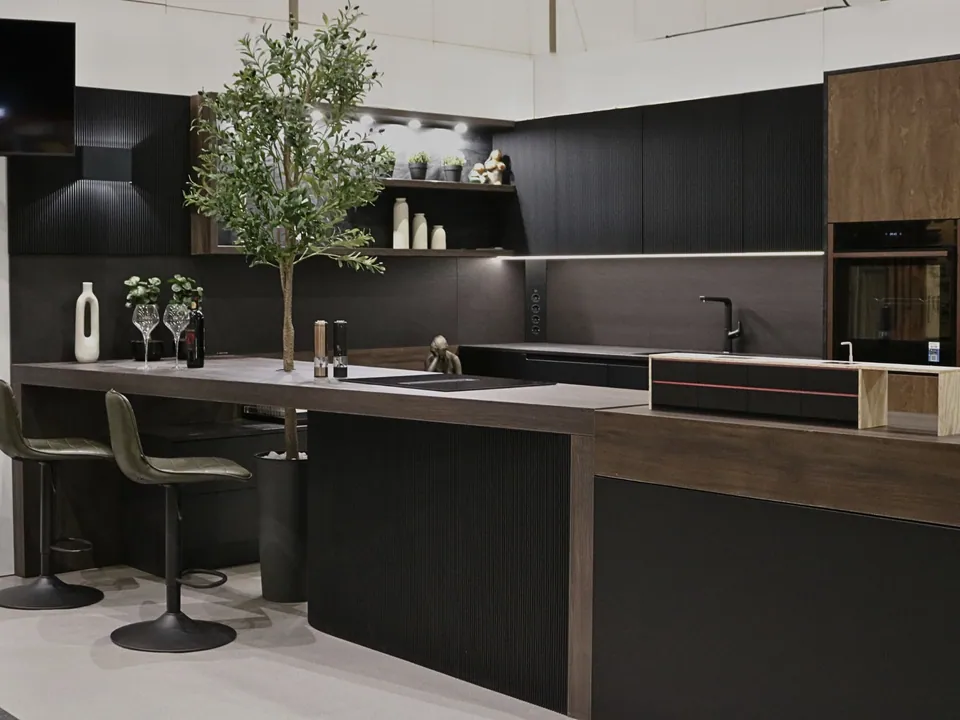 Exhibition kitchen with a height-adjustable worktop and an olive tree
