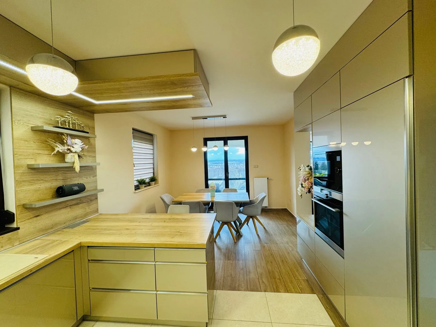 Kitchen with a wood-clad ceiling element