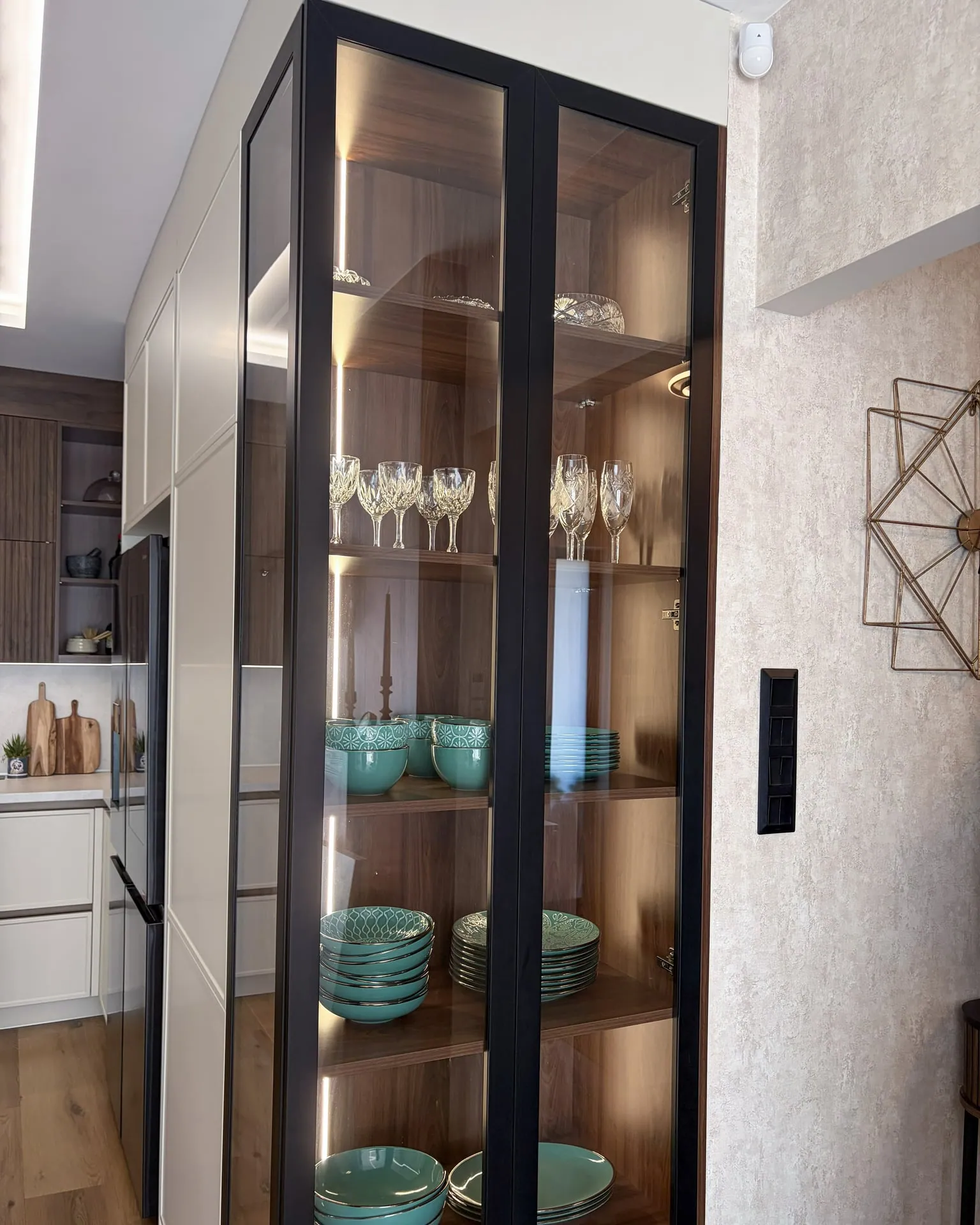 Black aluminium-framed, illuminated display cabinet on the end unit