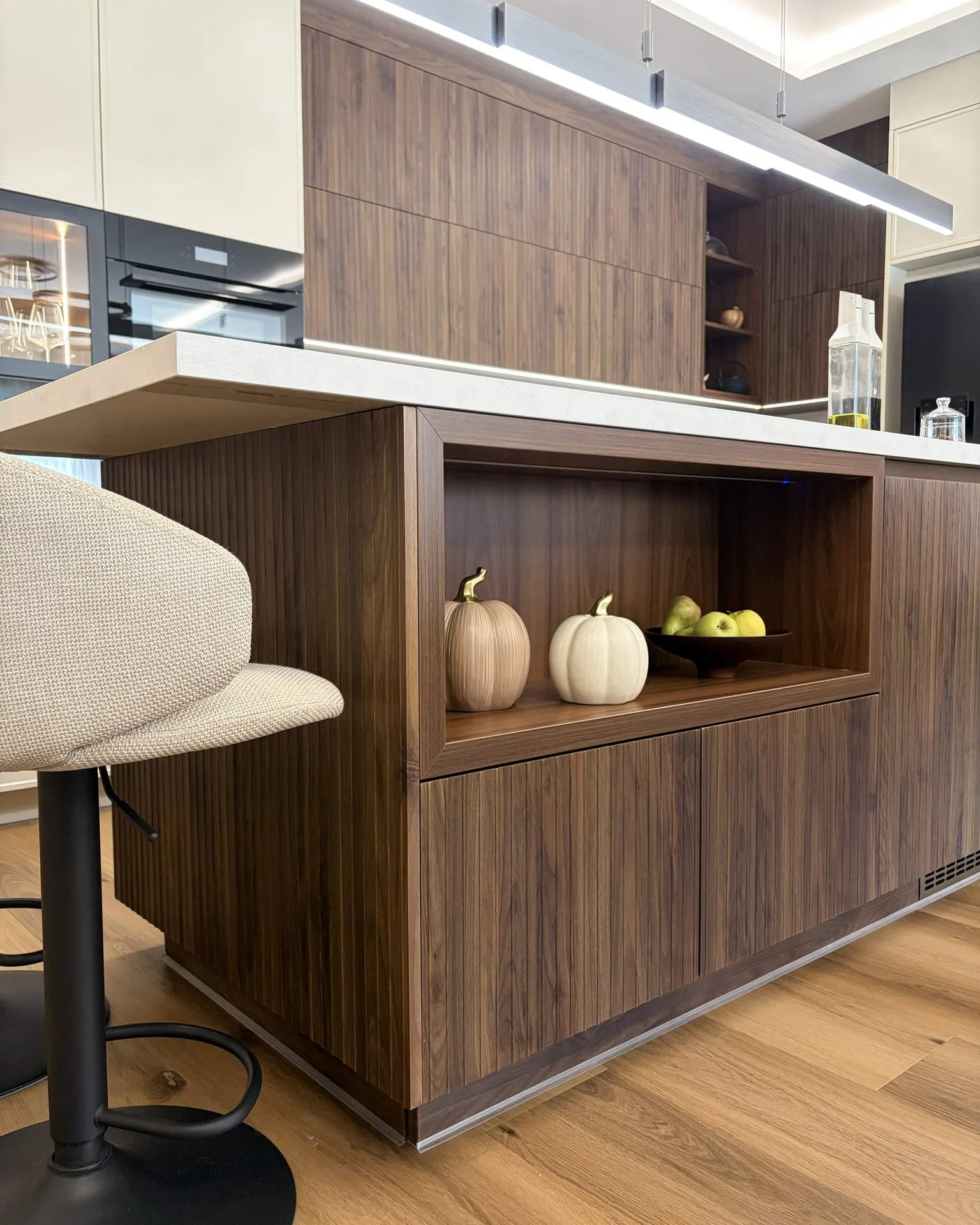 The open element of the island, mitred at 45 degrees, with ribbed walnut fronts