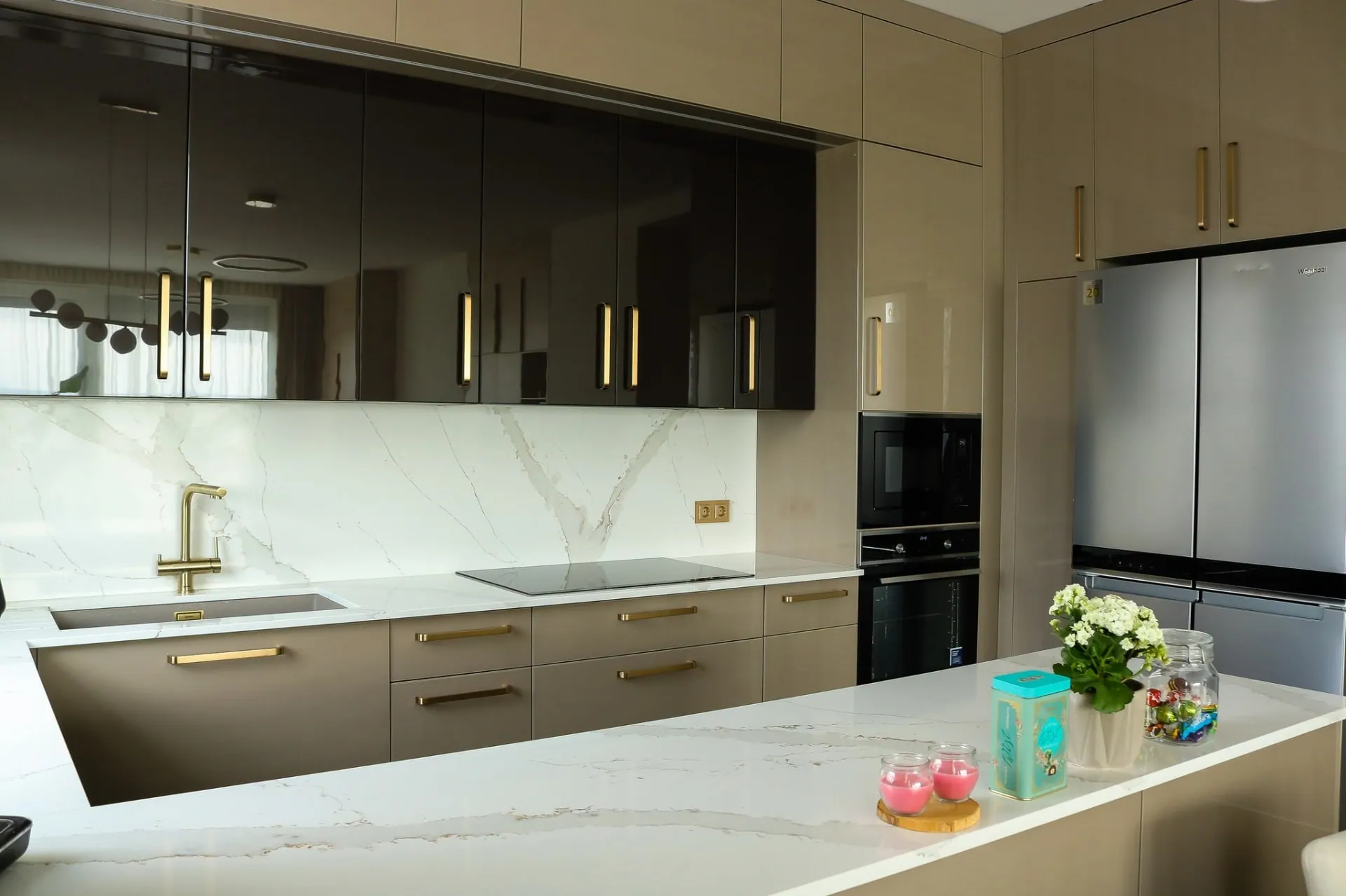 Kitchen with built-in appliances and an American-style fridge