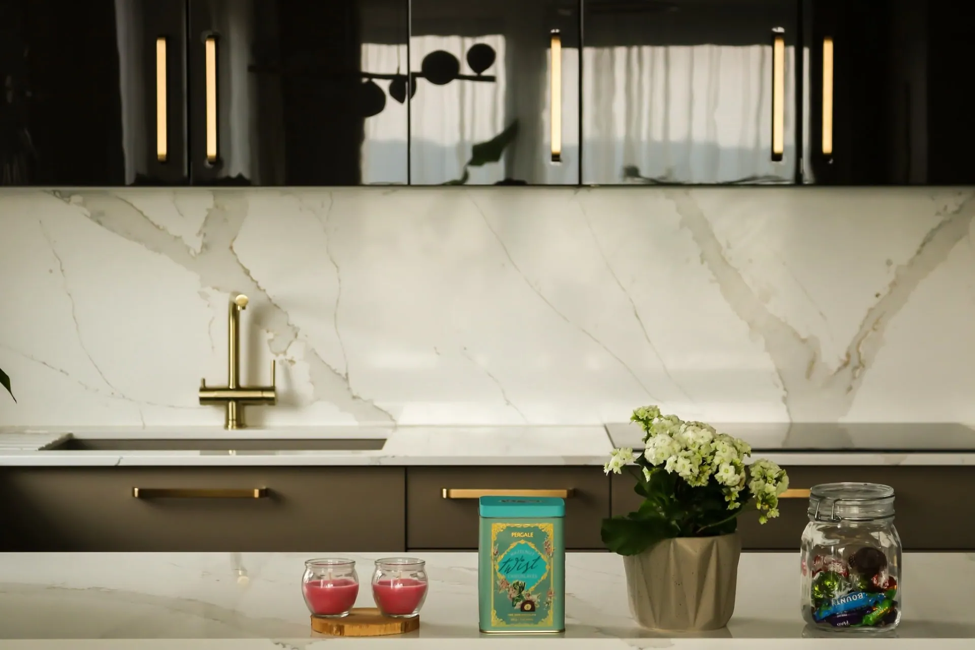 Gold tap and marble-effect splashback