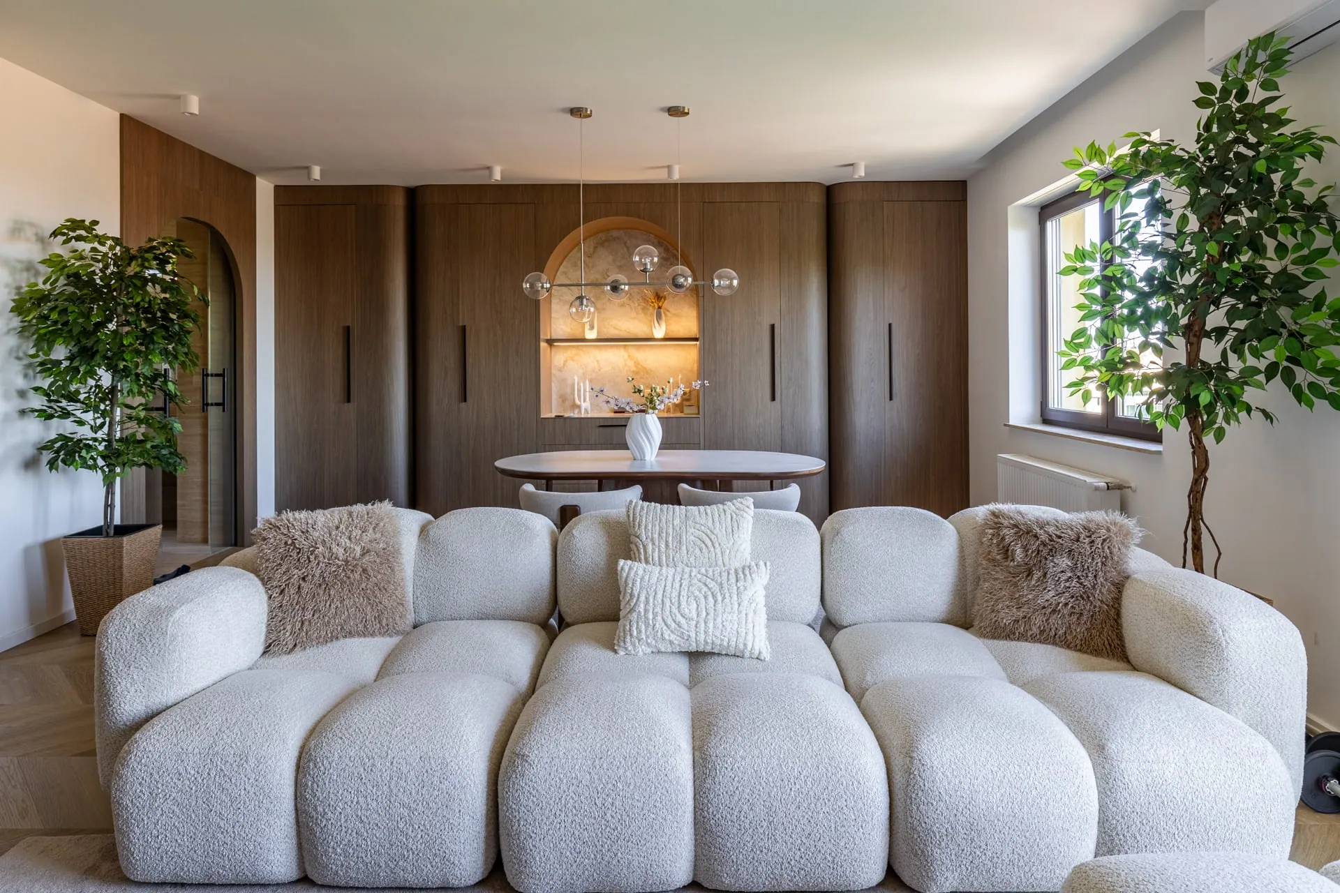 Japandi-style living room with a bespoke wooden panel wall and dining area