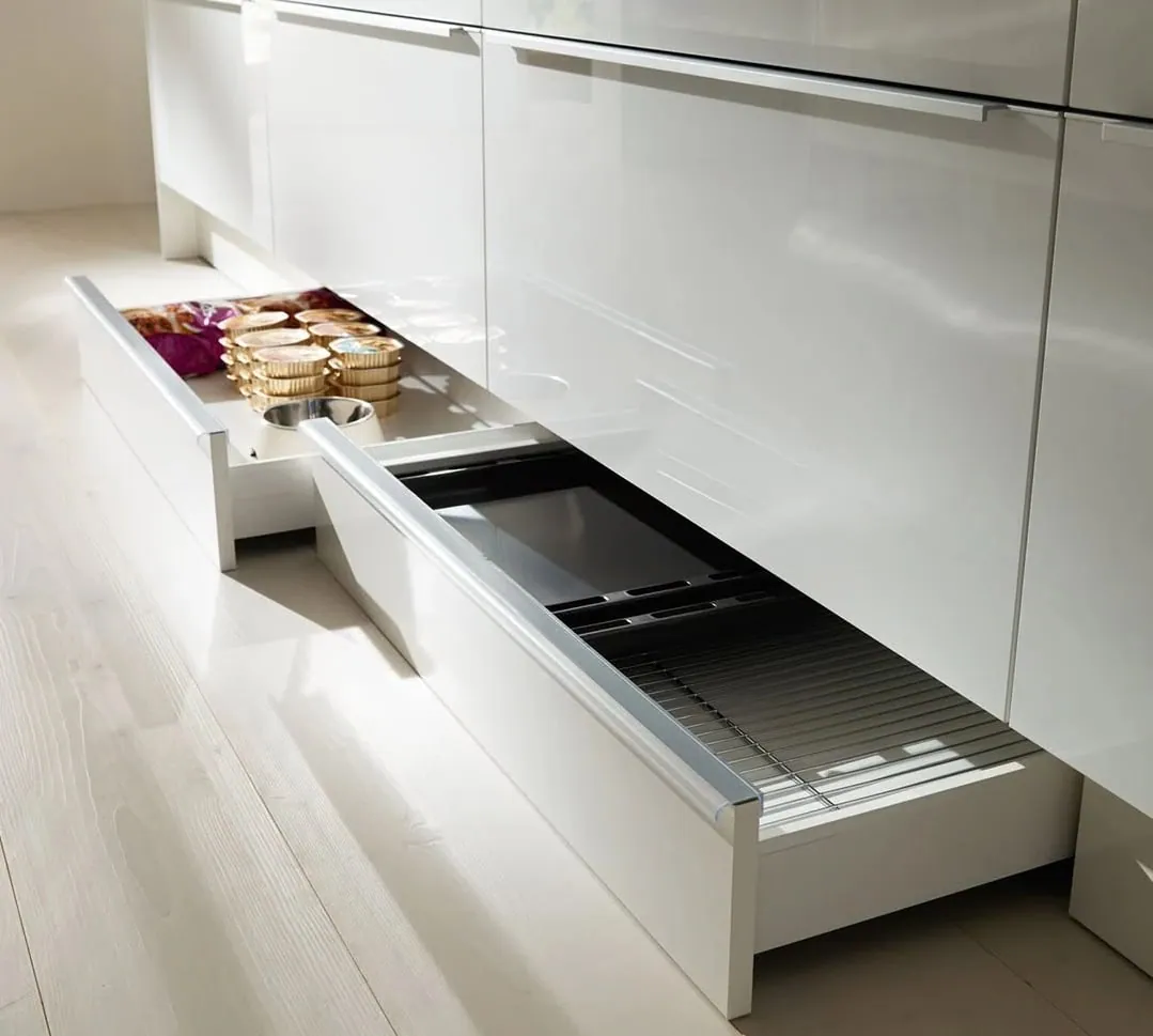 Plinth drawer pulled out in a white kitchen